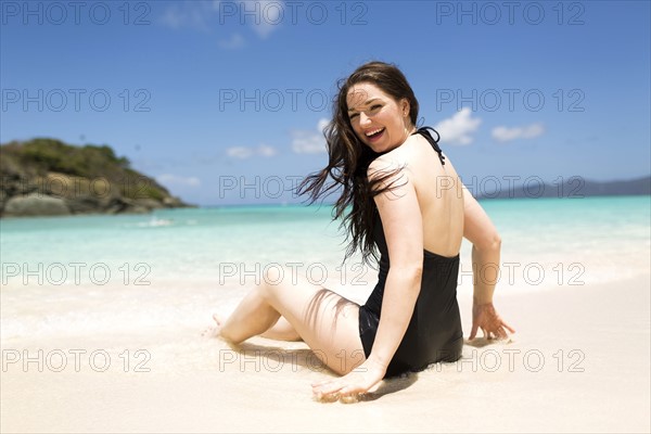 USA, Virgin Islands, Saint Thomas, Beautiful woman sitting on shore