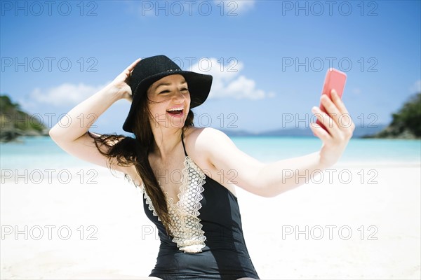 USA, Virgin Islands, Saint Thomas, Woman doing selfie on beach at sunny day