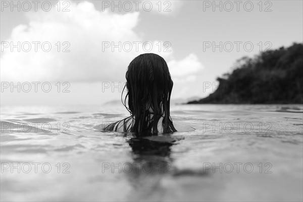 USA, Virgin Islands, Saint Thomas, Woman with long hair standing in bay