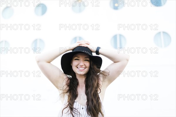 Cheerful woman in black hat