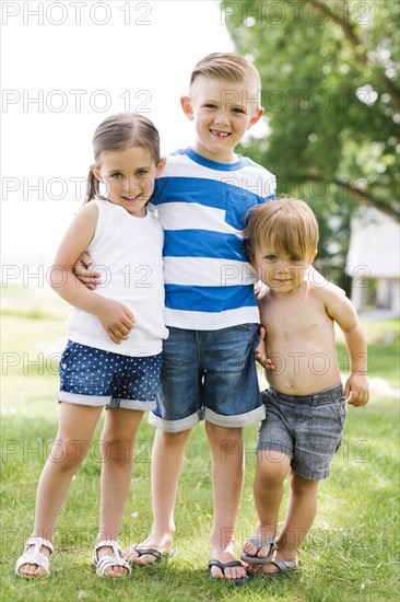 Siblings (2-3, 4-5, 6-7) embracing in park