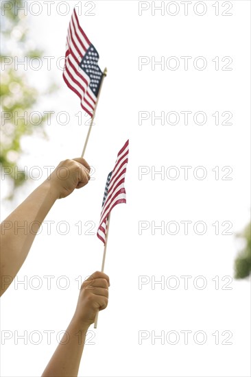 American flags holds by boy (6-7) and girl (4-5)
