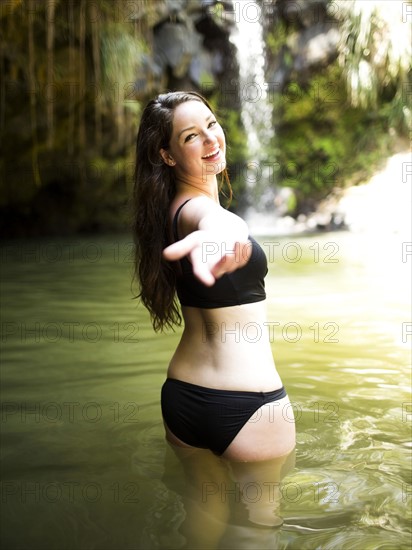 Caribbean Islands, Saint Lucia, Woman in water reaching hand towards camera