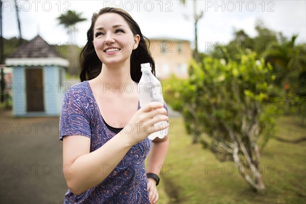 Caribbean Islands, Saint Lucia, Woman holding bottle
