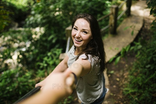 Caribbean Islands, Saint Lucia, Smiling women standing on path, holding person's hand and looking at camera