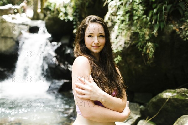 Caribbean Islands, Saint Lucia, Women by waterfall hugging self