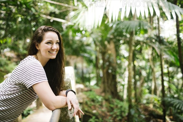 Caribbean Islands, Saint Lucia, Women leaning on fence in tropical forest