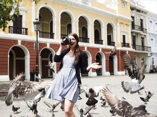 Puerto Rico, San Juan, woman on square among pigeons