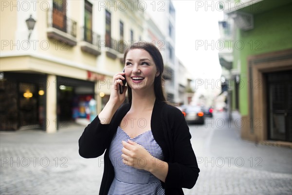 Puerto Rico, San Juan, woman on square talking on smartphone