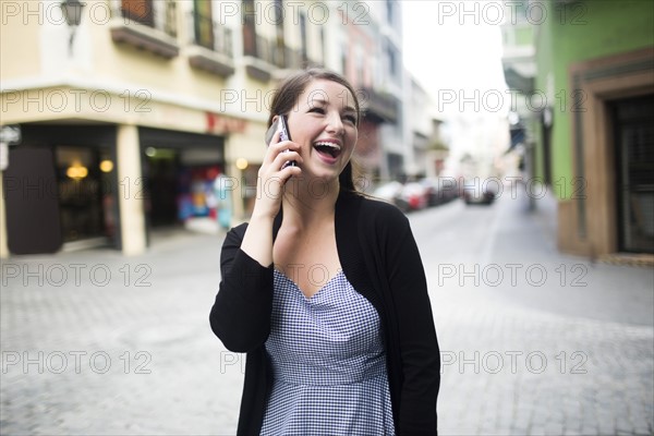 Puerto Rico, San Juan, woman on square talking on smartphone