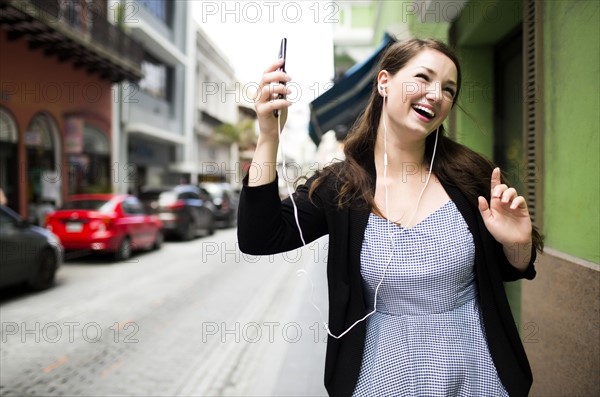 Puerto Rico, San Juan, Woman listening to music on street