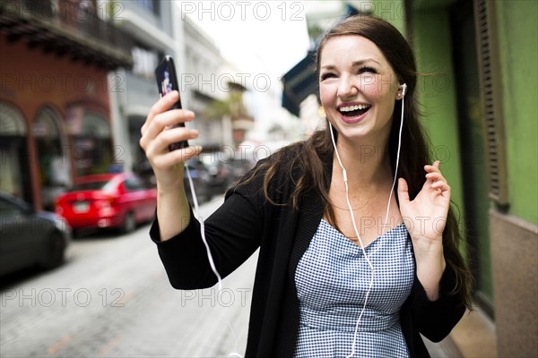 Puerto Rico, San Juan, Woman listening to music on street