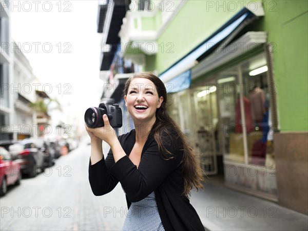 Puerto Rico, San Juan, Woman photographing on street