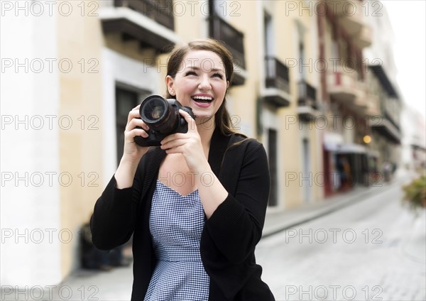 Puerto Rico, San Juan, Woman photographing on street