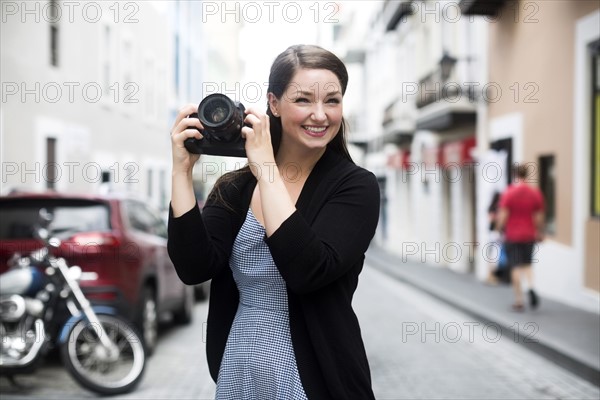 Puerto Rico, San Juan, Woman photographing on street