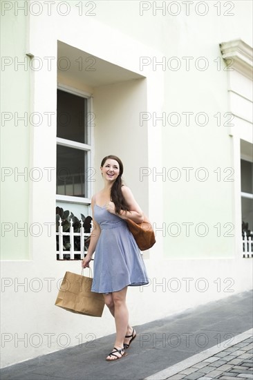 Puerto Rico, San Juan, Happy woman with shopping bag