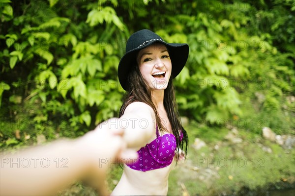 Cheerful woman taking selfie in forest