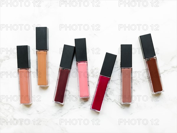 Lip glosses on marble background