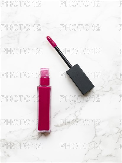 Lip gloss on marble background
