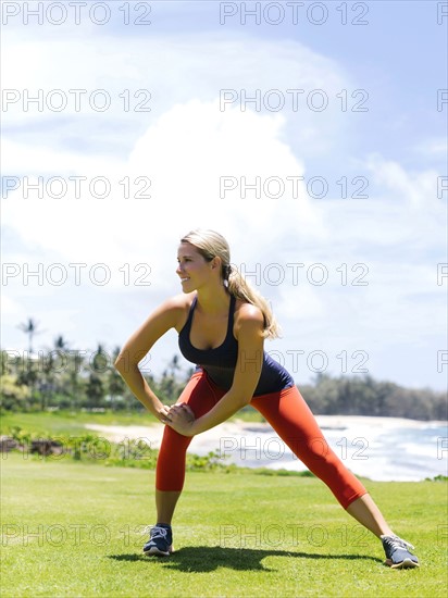 USA, Hawaii, Kauai, Woman exercising on beach