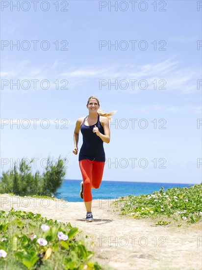 USA, Hawaii, Kauai, Woman jogging on beach
