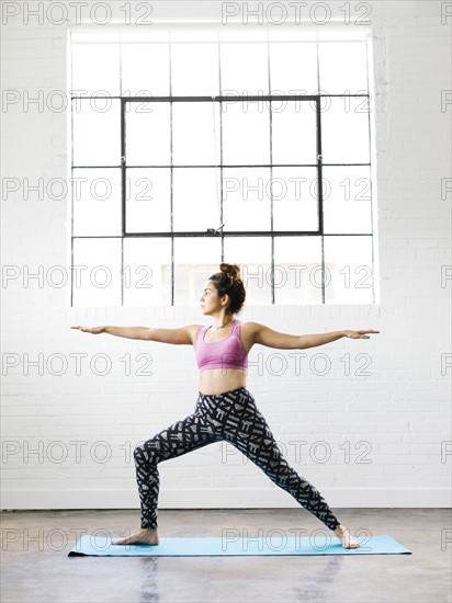 Woman practicing yoga on exercise mat