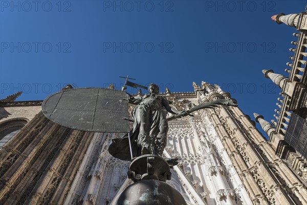 Spain, Seville, Facade of Cathedral of Seville with statue