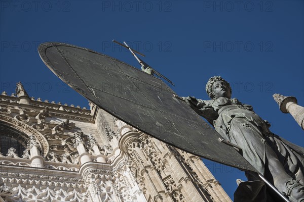 Spain, Seville, Facade of Cathedral of Seville with statue