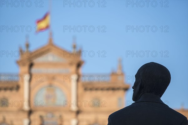 Spain, Seville, Plaza De Espana, Silhouette of male statue with building in background