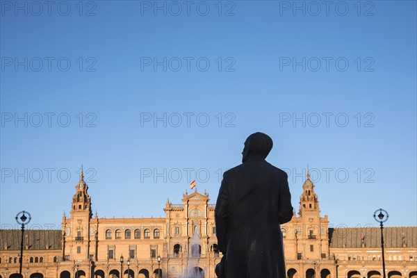 Spain, Seville, Plaza De Espana, Silhouette of male statue with building in background