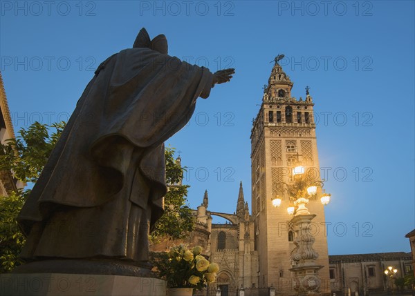 Spain, Seville, Plaza Virgin De Los Reyes, Statue and Girlada Tower