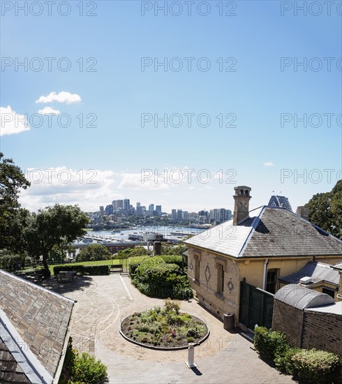 Australia, New South Wales, Sydney, Courtyard of house with city skyline in background