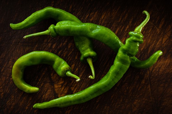 Long hot peppers on wooden table