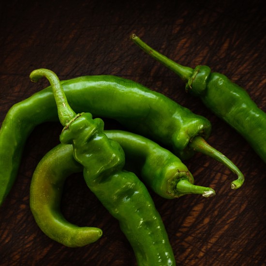 Long hot peppers on wooden table