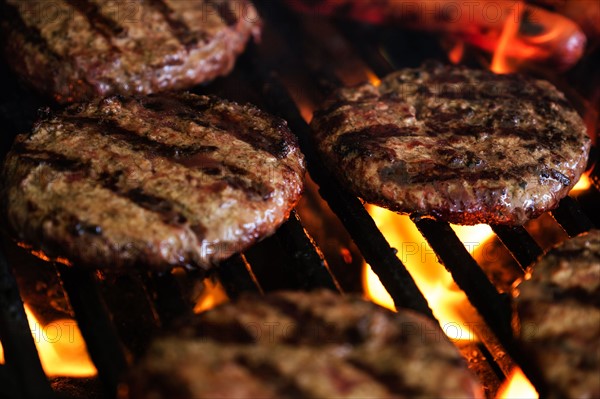 Hamburgers and hot dog on barbeque grill