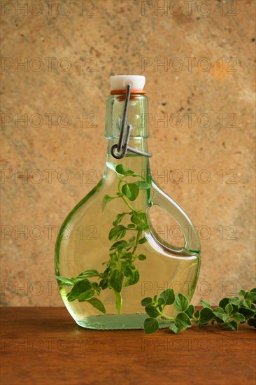 Olive oil bottle with oregano leaves