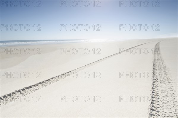 Tire tracks on empty beach
