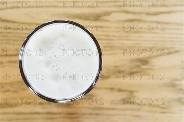 One pint of beer on wooden counter