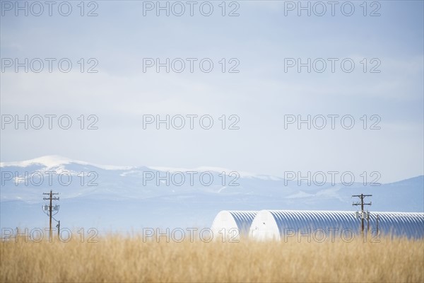 USA, Colorado, Agricultural landscape with snowcapped mountains in background
