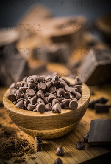 Bowl of chocolate chips on cutting board