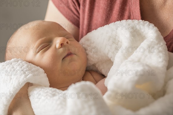 Baby boy (0-1 months) in mothers arms