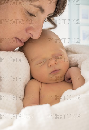 Mother embracing newborn son (0-1 month)