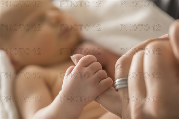Newborn son (0-1 month) holding father's finger