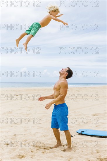 Father with son (4-5) playing at beach