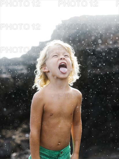 Boy (4-5) playing with rain