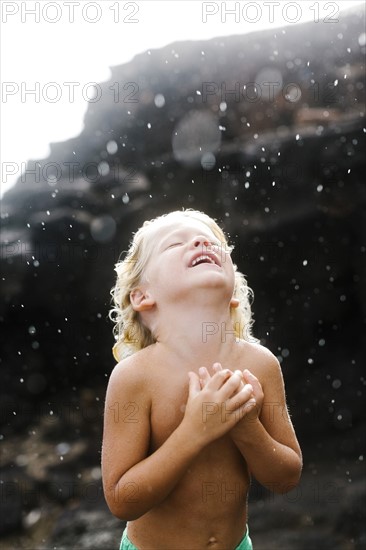 Boy (4-5) playing with rain