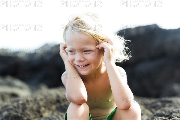 Boy (4-5) playing on rocks