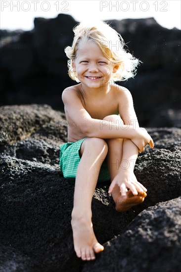 Boy (4-5) playing on rocks