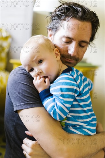 Father embracing son (12-17 months)