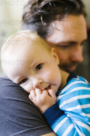Father embracing son (12-17 months)